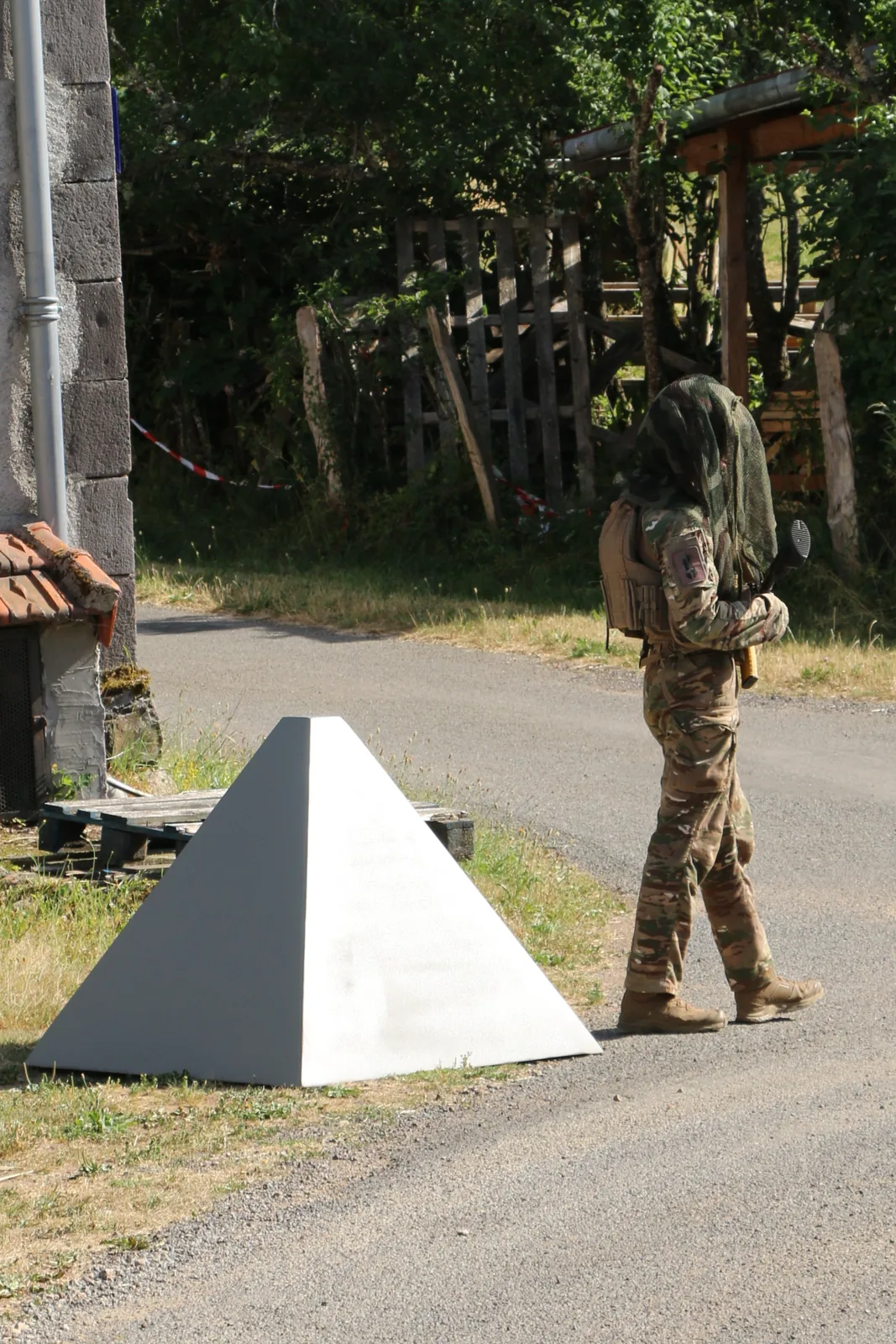 Combattant en surveillance à proximité d'un obstacle de déception MilDecPro en zone semi-urbaine